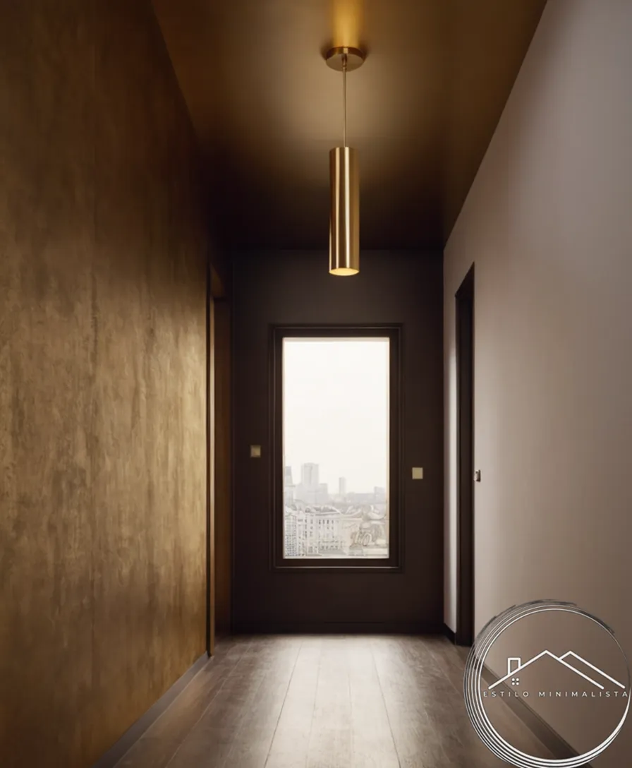 A minimalist golden pendant light illuminating a narrow hallway.