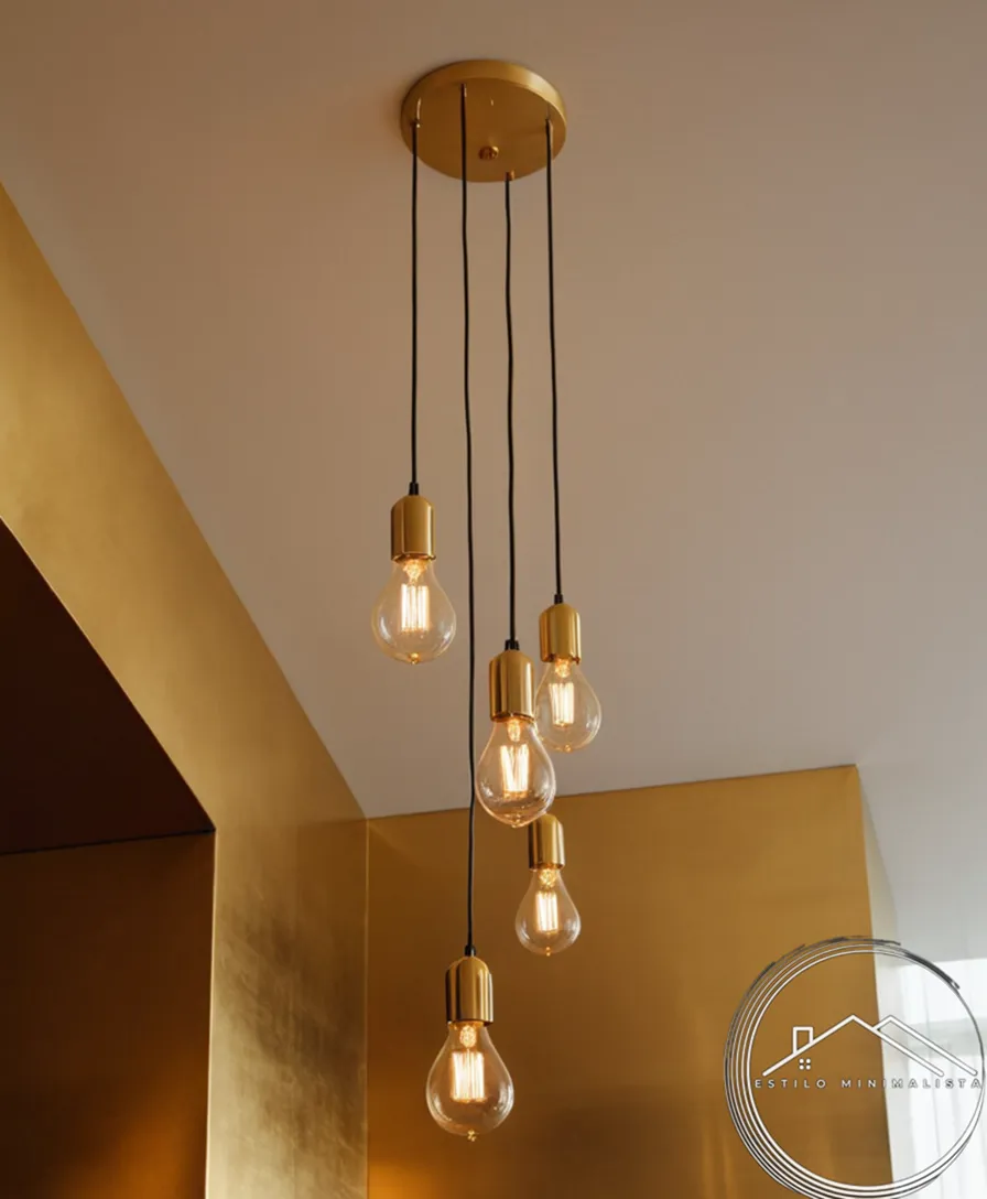 3 minimalist pendant lamps hanging from a golden ceiling.